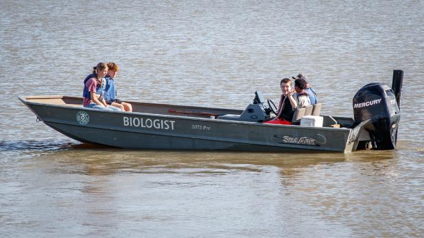 Wes Dutter with Texas Parks & Wildlife offered boat rides around the lake, while other students enjoyed skipping rocks on the lake while chatting.