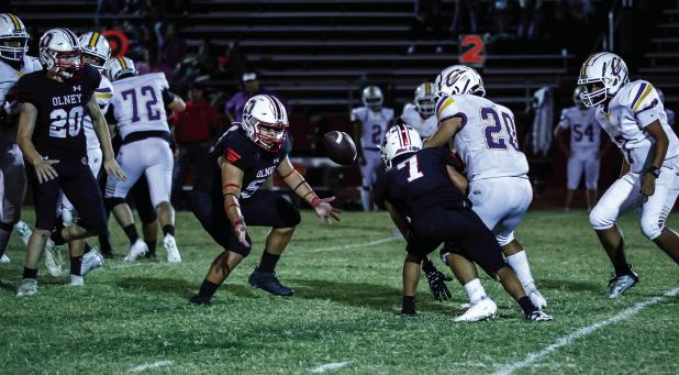 The Olney HIgh School Cubs showed their mettle in their homecoming game at Cub Stadium on Oct. 3 with a 33-0 rout of the Crosbyton Chiefs. Here, OHS Cub Ricco Sandoval (#55) showed he could run as well as guarding the quarterback and making running plays