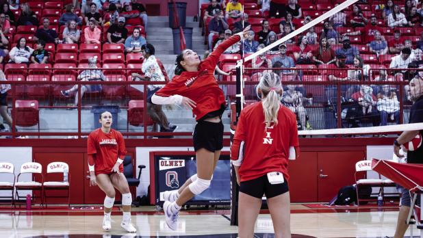 Lady Cub #12 Halee Craven hits a volley over the net to waiting little sisters who are eagerly helping their big sisters during practice. | Photo by Will Sadler