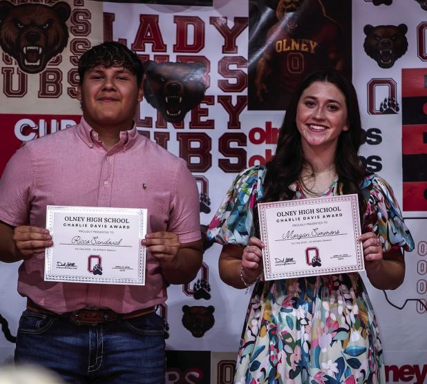 Ricco Sandoval (L) and Morgan Simmons (R) show off their Charlie Davis Awards at the OHS Athletic Banquet. Photo by Will Sadler