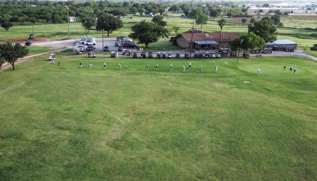 Golfers in the CEMCO Invitational begin the tourney with warming up at the driving and putting green. Photo by Will Sadler