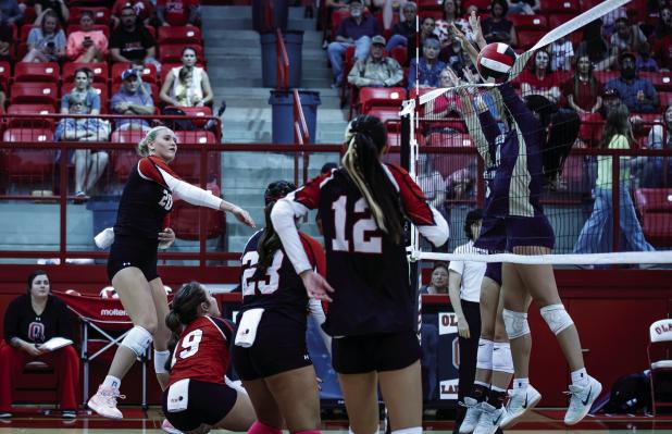 Lady Cub #20 Natalie Simmons has grown into a confident powerhouse for the Lady Cubs over the last two seasons. Shown with a powerful slam against two Lady Pirate defenders. | Photo by Will Sadler