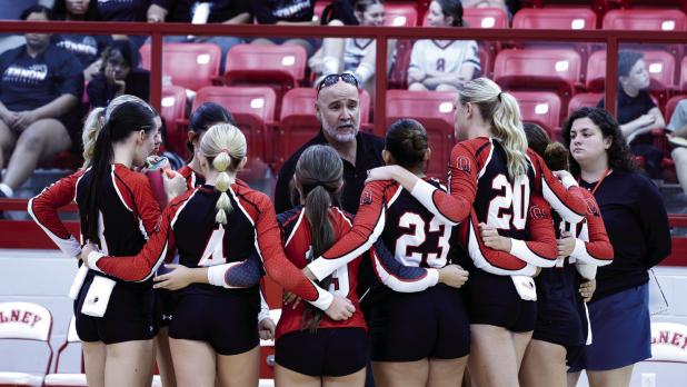 The Lady Cubs huddle for last-minute instructions from OHS Volleyball Coach Nicholas Tarr. Photo by Will Sadler