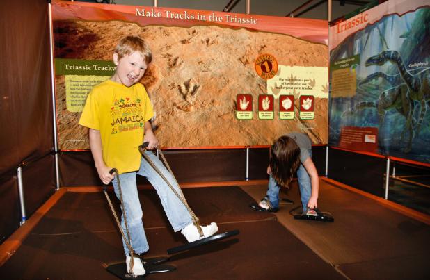 Dinosaur lovers practice “making tracks” at the Dinousaur Revolution at The Old Post Office in Graham. Photo provided by The Old Post Office