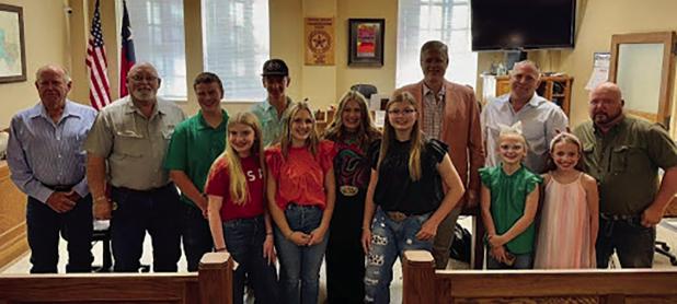 4Hers made a presentation to Young County Commissioners on Oct. 14 to mark National 4H Week. (L-R): Commissioner Alan Craig, Commissioner Jimmy Wiley, Kutter Gough, Ella Buse, Colt Crago, Lexi Gowens, True Creel, Addison Greenwood, Judge Win Graham, Peyto