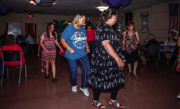 Attendees of the Cub Centers Summer Dance enjoying line dancing during the evening of fun. Photo by Will Sadler