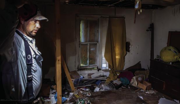 Veteran OVFD Captain Jason Pack gave a tour of the home before the training began. Pack said once a house is filled with smoke, sometimes the only way to find their way out is by following the fire hose back out the house. Photo by Will Sadler