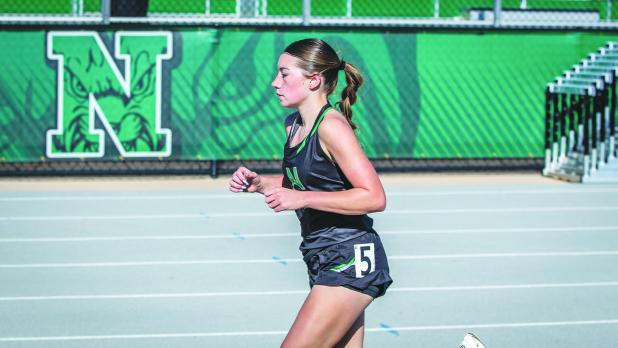 NHS Ladycat Greenleigh Moore followed closely behind her teammate in the 3200 earning the second-place finish. Photo by Will Sadler
