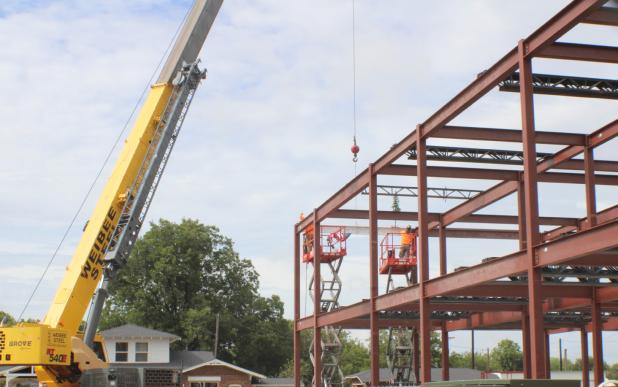 A crane lifts the final beam into place at the First Baptist Church of Olney’s new education building. The 17,300 square foot building will be completed in the first quarter of 2027. Photo by Gina Keating