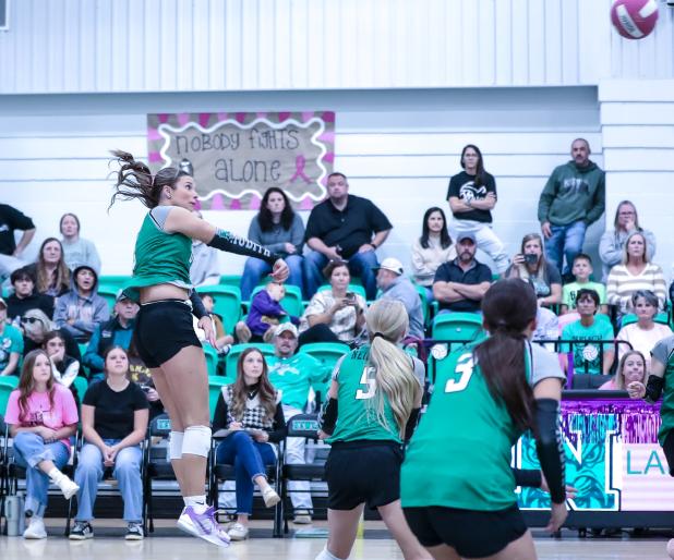 NHS Senior Ladycat #0 Kenzie King sends a rocket kill shot across the net at Lady Longhorn defenders.
