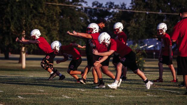 Cub offensive linemen practice techniques that will later become second nature during upcoming scrimmages and games. Photo by Will Sadler
