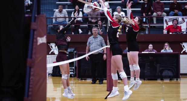 Lady Cub defenders #20 Natalie Simmons and #12 Morgan Simmons guard at the net with a successful block against Lady Panther hitters. Photo by Will Sadler