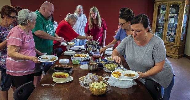 Attendees of the Cub Center July game night enjoyed delicious homemade dishes and good conversation before breaking off into smaller groups to play games. Photo by Will Sadler
