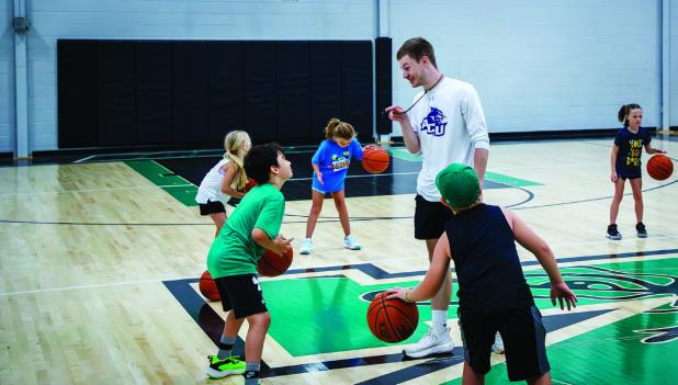 Coach Lane Dollar made sure the children attending his basketball camp not only learned valuable skills but also how to have fun during the process. Photo by Will Sadler