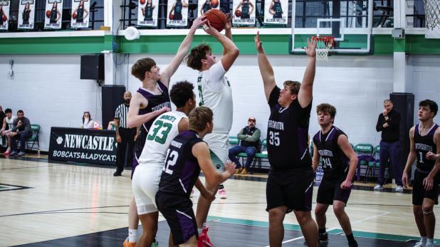 Bobcat #21 Jayden Hemby drives through Greyhound defenders and launches a floater. Photo by Will Sadler