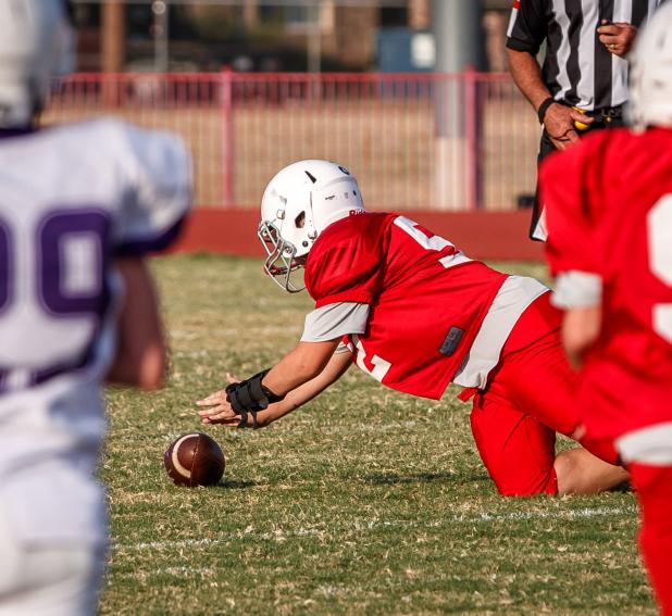 Cub #52 Alex Cody dives on the ball, securing a Cub fumble recovery. Photo by Will Sadler