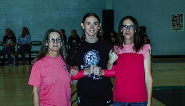 Aubree is escorted by Sonya and Trista Clayton during Senior Night. Photo by Will Sadler