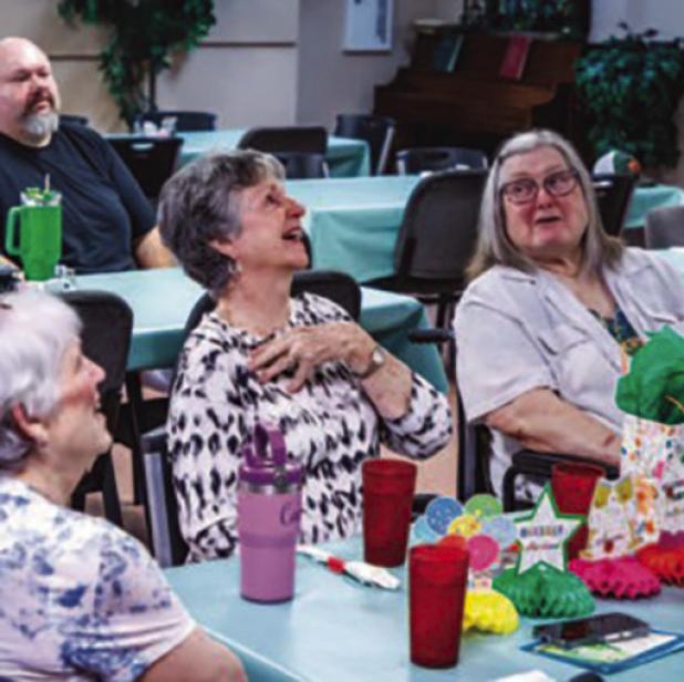 Edwana Fikes, a longtime volunteer at the Olney Senior Cub Center, reacts to thanks by Center director Angela Lockard, who lauded Mrs. Fikes for her long service to the Senior Cub Center. Mrs. Fikes announced her retirement in July. Photo by Will Sadler