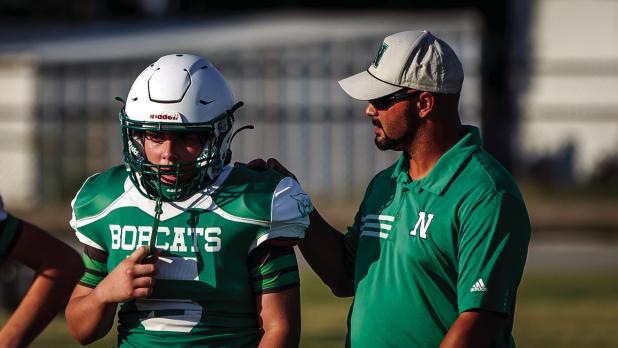 Words of encouragement come from Coach Isiah Archer to a young Bobcat player. Photo by Will Sadler