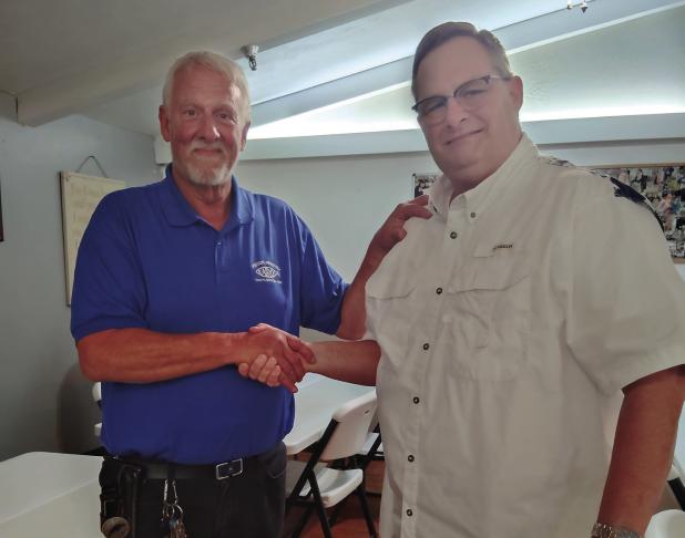 Preston Crow congratulated by his son-in-law Rob Goodin, the former Olney Police Chief. Photo by Gina Keating