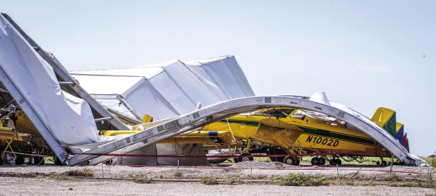 A powerful thunderstorm swept into town on Sunday, July 5, causing damage across Olney and twisting Air Tractor’s temporary hangar on top of 16 aircraft. Photo by Will Sadler