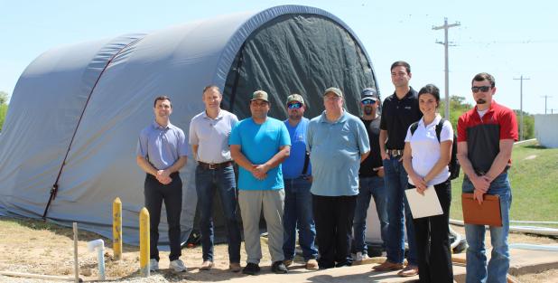 City officials stand in front of the DOW demonstration unit at the Olney Water Treatment Plant, along with representatives from Jacob | Martin, and competitor Aria Filtra, whose unit was also placed at the site. A third vendor, Purifics, withdrew from the