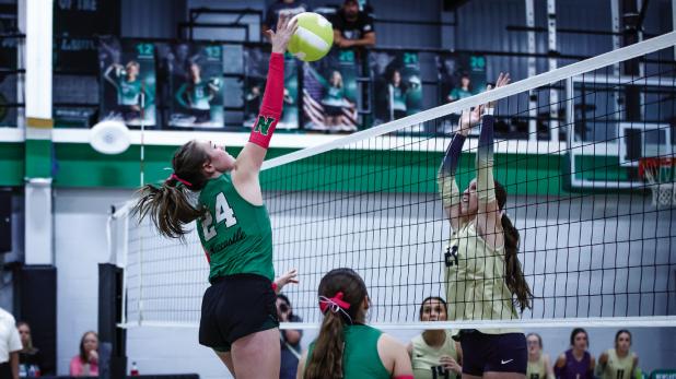Ladycat #24 Sophie Terrell spikes a kill shot past a Lady Pirate defender. Photo by Will Sadler