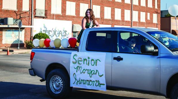 OHS Homecoming Queen nominee Bradi Bowers waves to parade attendees. Photo by Will Sadler