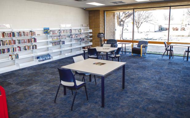 New white shelving, carpet and furniture give the library’s main room a clean, bring look. Photo by Will Sadler