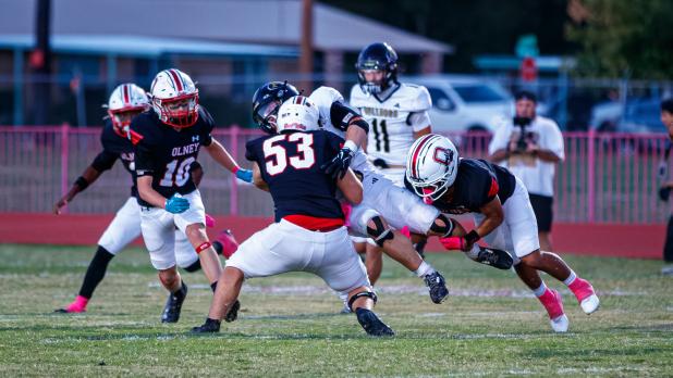 OHS Cubs #53 Kanin Beavers and #7 Damian Hernandez team up to take down a Bulldog runner. Photo by Will Sadler