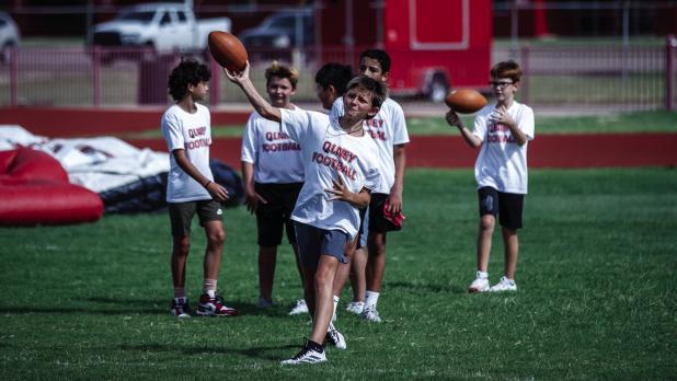 Football camp teaches many skills like passing while instilling competitive spirit with awards for each station for the top performers. Photo by Will Sadler