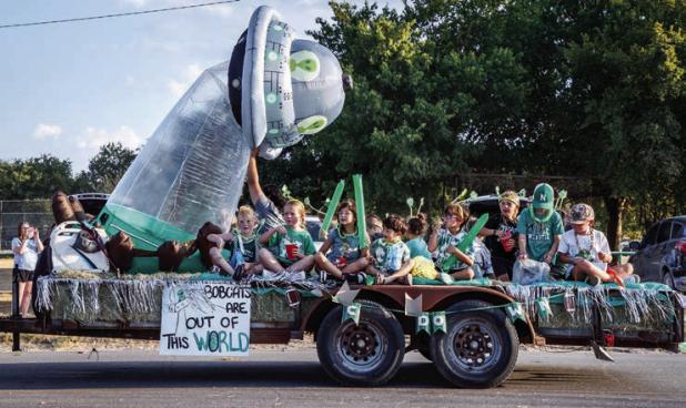 These young Bobcats and Ladycats think the Bobcats are out of this world, and their awesome float during the HOCO parade shows it. | Photo by Will Sadler