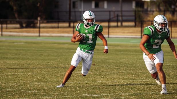 A Bobcat running back looks downfield for his opening toward the goal. Photo by Will Sadler