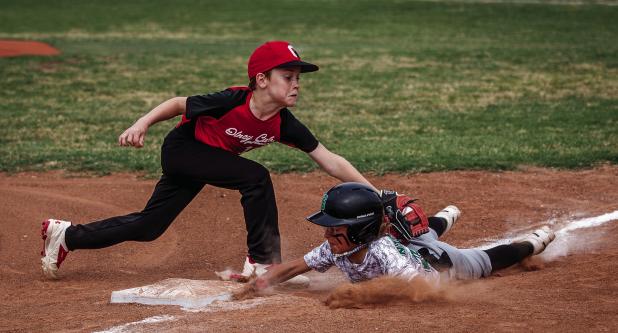 Olney Cub #10 Brayson Betts tags an opponent out at third base. Photo by Will Sadler