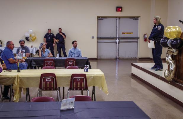 Olney Police Detective Autumn Thames gave a speech and presented outgoing Olney Police Chief Dan Birbeck with a special challenge coin during his going away luncheon. Photo by Will Sadler