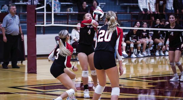 Lady Cub #4 Mackenzie Berngen saves a kill and sends a volley over the net to Lady Panther defenders. Photo by Will Sadler
