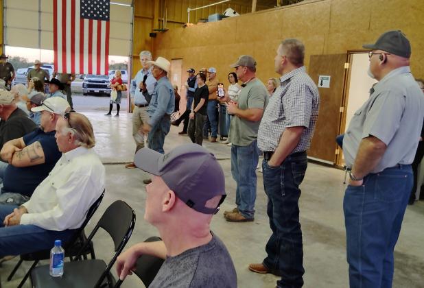 County Commissioners Jimmy Wiley and Scott Shook (standing on right) and Alan Craig and Stacy Creswell (sitting on left) listen as Young County residents question solar farm reps at the Eliasville-South Bend Volunteer Fire Department on Nov. 5. The projec