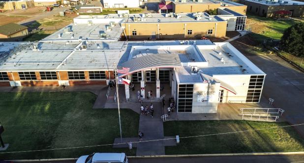 Olney Junior High students wait for the first bell outside the school. Photo by Will Sadler