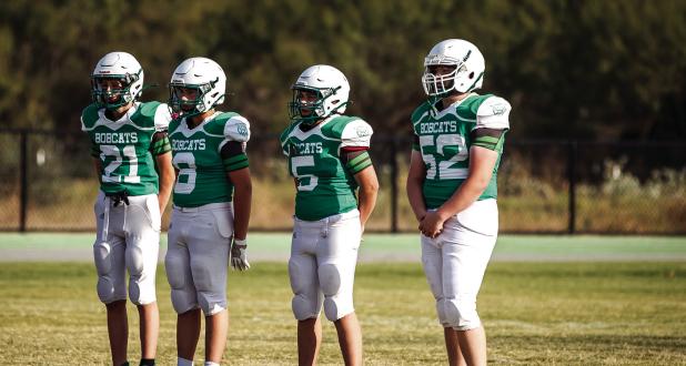 The NJH Bobcat Captains greet the May Tigers mid-field to shake hands and perform the coin toss. Photo by Will Sadler