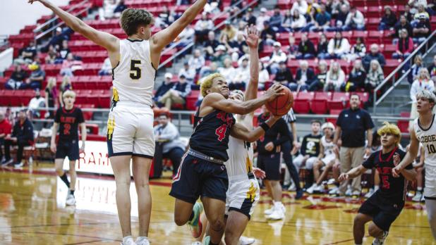 OHS Cub #4 Jamarcus Collins, Olney Enterprise Player of the Game, shown crashing through Lobos defense as he did all night. Collins would not be denied a big night for the Cubs. Photo by Will Sadler