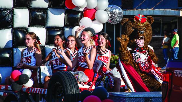 OHS Homecoming Queen nominee Rae Bond rides in style during the HOCO parade atop a 1960’s era Cub red Cobra. Photo by Will Sadler