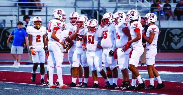 Cub #11 Tucker Cortinez QB-SS talks to teammates before going to the line. Cortinez has gained more confidence with each game, spreading out passes to several receivers and scrambling out of the pocket to pick up yards when needed to keep drives alive. Ph