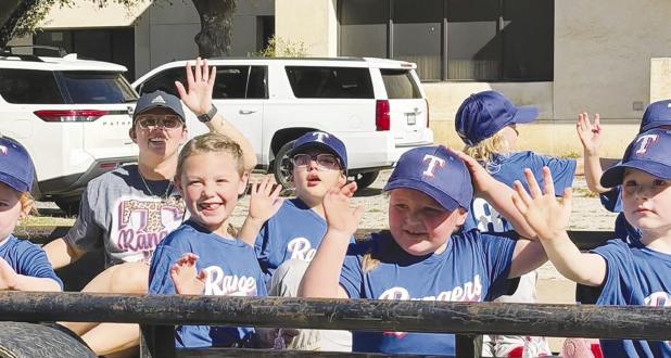 The Rangers Little League team greets well-wishers during the Little League parade on Saturday, opening the 2026 season. Photo by Kelsey Belyeu