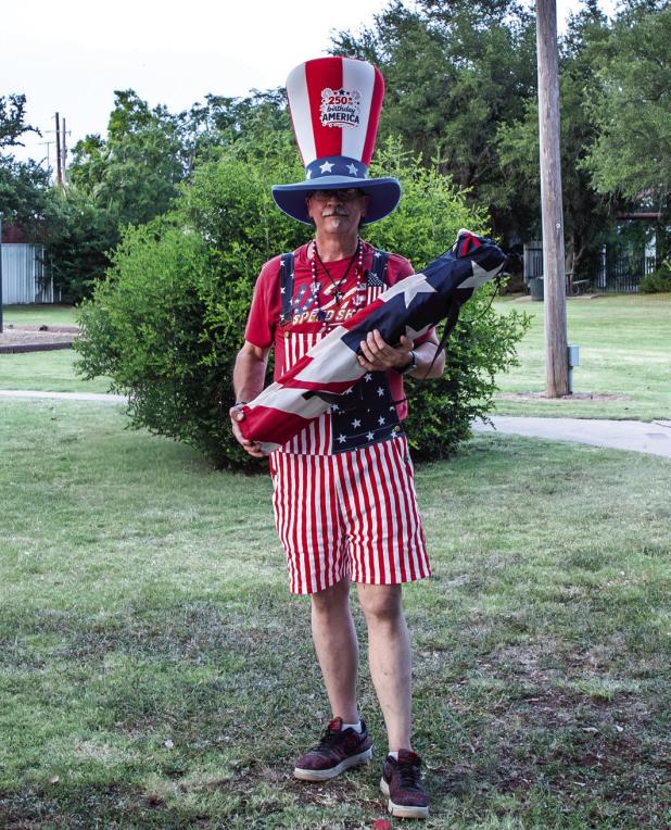 (Above): The Inge Family celebrates their third win for Most Patriotic entry in the Olney Fourth of July Parade at Tommy Perkins Park. (Left): Olney Enterprise photojournalist Will Sadler holds his prize, a camp chair donated by Archer and Gunn, for his M