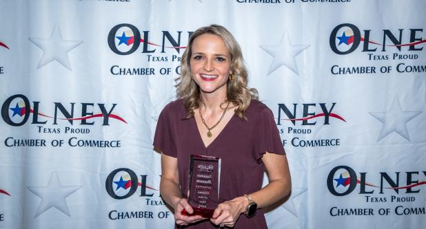 School board president Summer Branum shows off her award for Citizen of the Year at the Olney Chamber banquet. Photo by Will Sadler
