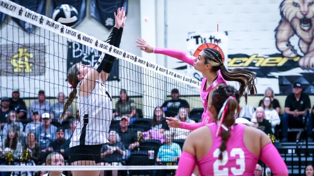 OHS Lady Cub #12 Halee Craven fires a kill shot across the net at district rival Ladycat defenders.