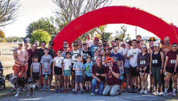 Participants and volunteers of the Sixth Annual Turkey Trot gathered at Tom Griffin Park on Sunday, Nov. 16. Participants warmed up with a prayer and a chicken dance. The event raised money for The Refuge and its Christian-based after-school programs, sum