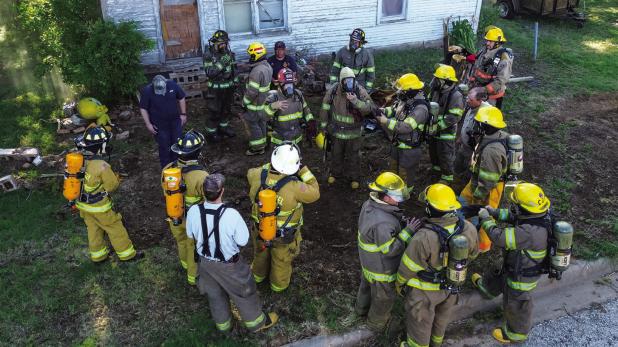 Firefighters review breaching and safety after the first teams had a run-through. Photo by Will Sadler