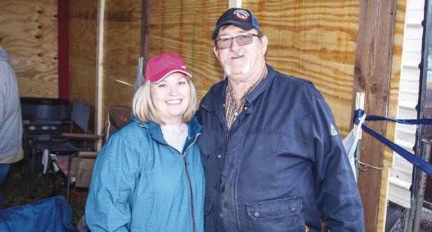 Tami and Jeff Harvey pause for a photo in between coordinating volunteers and delivering meals to curb side donators. The fundraiser included a drink, BBQ sandwich, chips and cookie for $10. Photo by Will Sadler