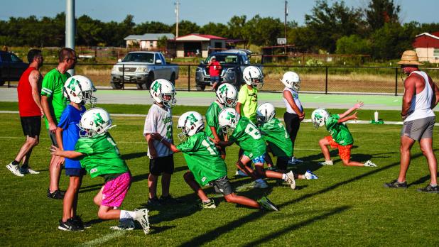 Bobcat practice began for the smaller Cats as well. The little league took the field to begin preparations for a successful season, and part of that success will count on great tackle technique. Bobcats are shown running tackles and blocking drills before